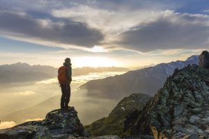 Hiker on mountain enjoying the view as metaphor for Central Bank Digital Currency and its impact on the banking system