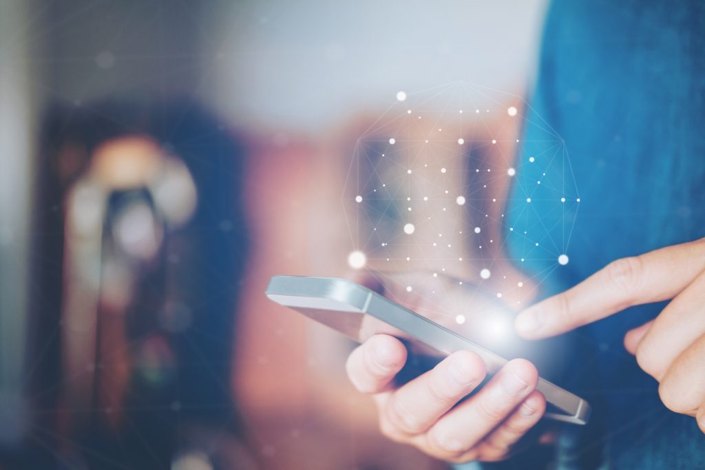 Businessman using mobile phone as a metaphor for the article "Mobile payments in Germany—a heterogenous market"