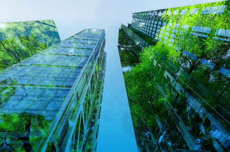 skyscrapers overgrown with green trees as metaphor for the ESG transformation advancing